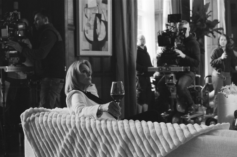 Black-and-white image of Joanna Lumley as Judith Baker sitting on a couch in Season 1 of 'Fool Me Once'