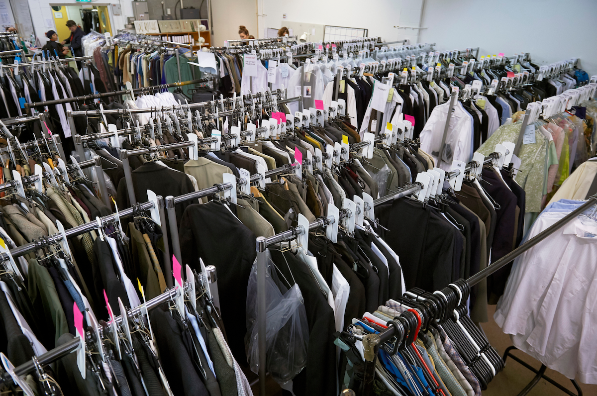 Room full of costumes hanging on clothing racks