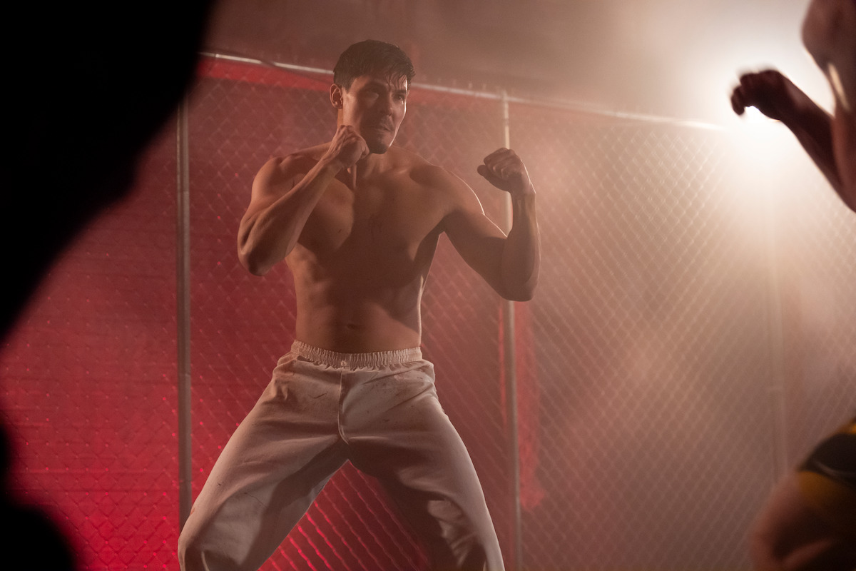 Lewis Tan as Sensei Wolf raises his fists in a fighting stance in Season 6 of ‘Cobra Kai’