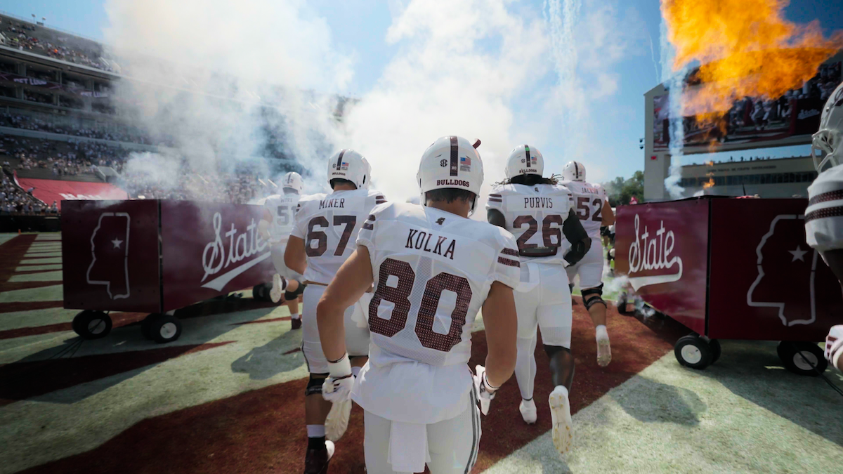 Mississippi State players running onto the field.