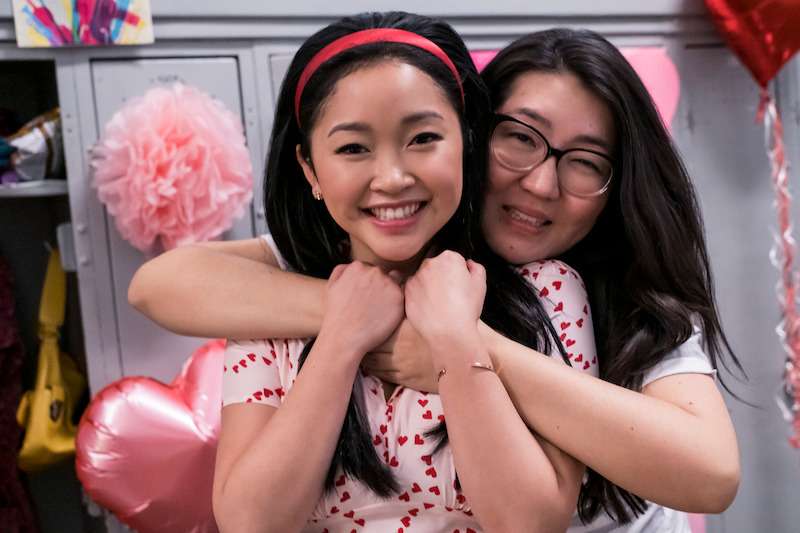 Lana Condor as Lara Jean and Jenny Han hugging on set.