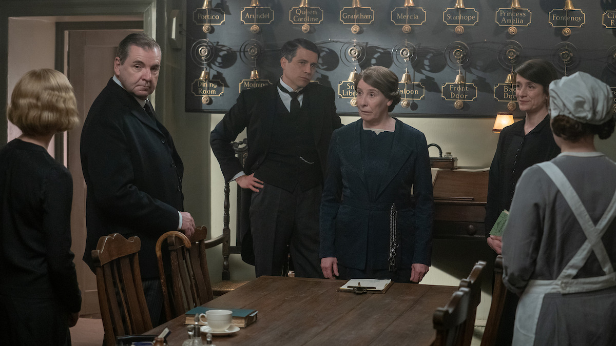 Robert James-Collier, as Thomas Barrow, and Jim Carter, as Charles Carson, hold a staff meeting in ‘Downton Abbey: A New Era.’