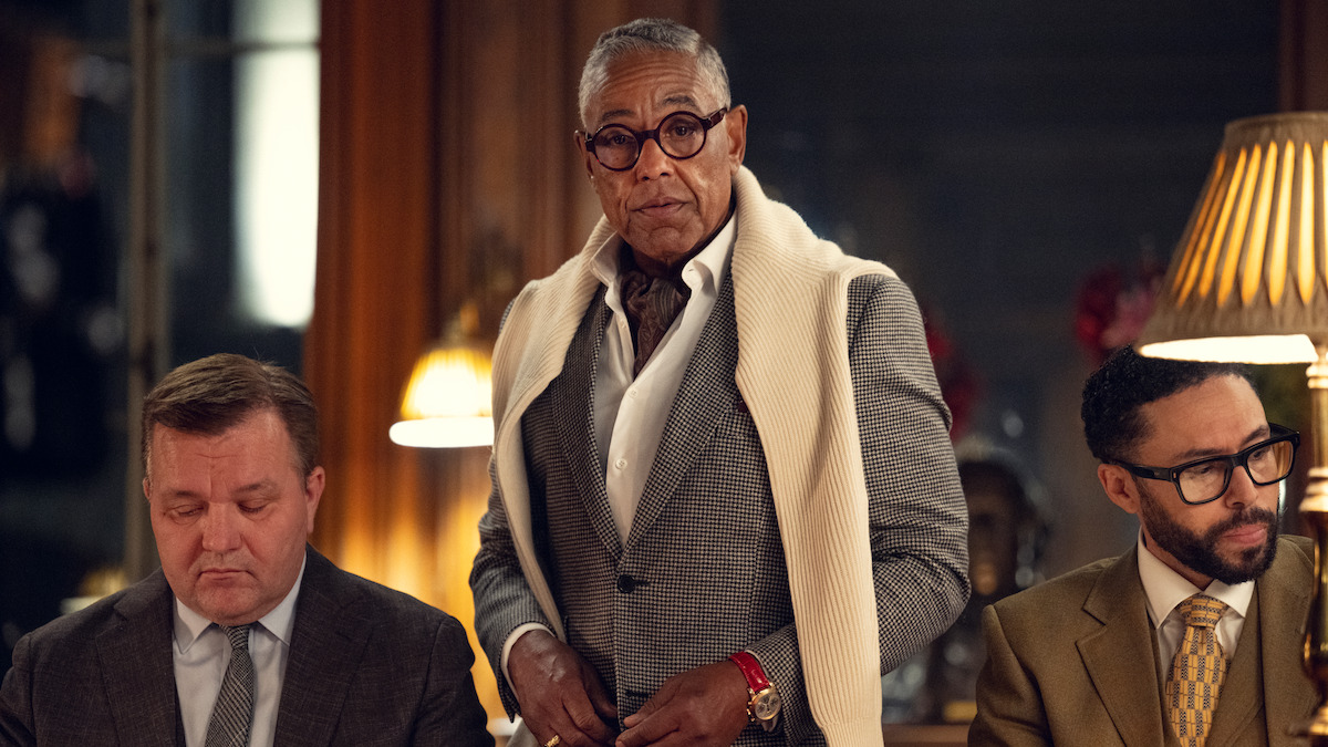 Giancarlo Esposito as Uncle Stanley Johnston stands in an office wearing a gray in Season 1 of ‘The Gentlemen.’