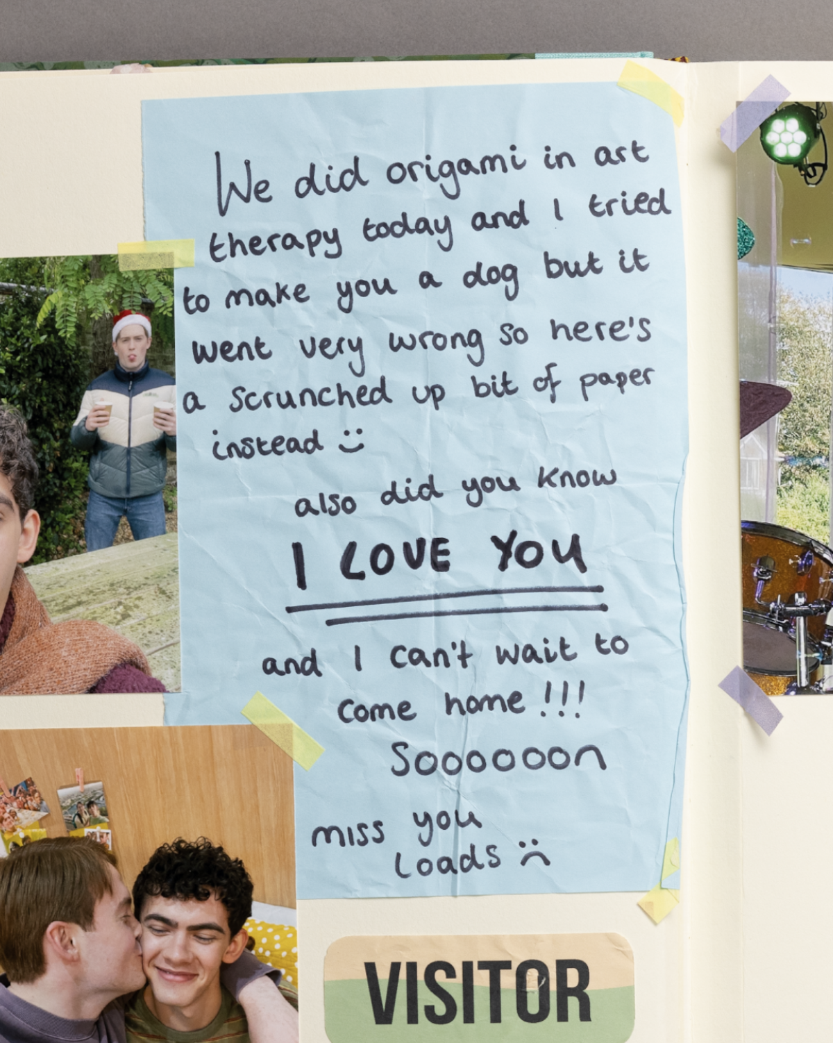 A scrapbook page with a handwritten note on blue paper, surrounded by photos of people, taped with colored tape, on a cream background.