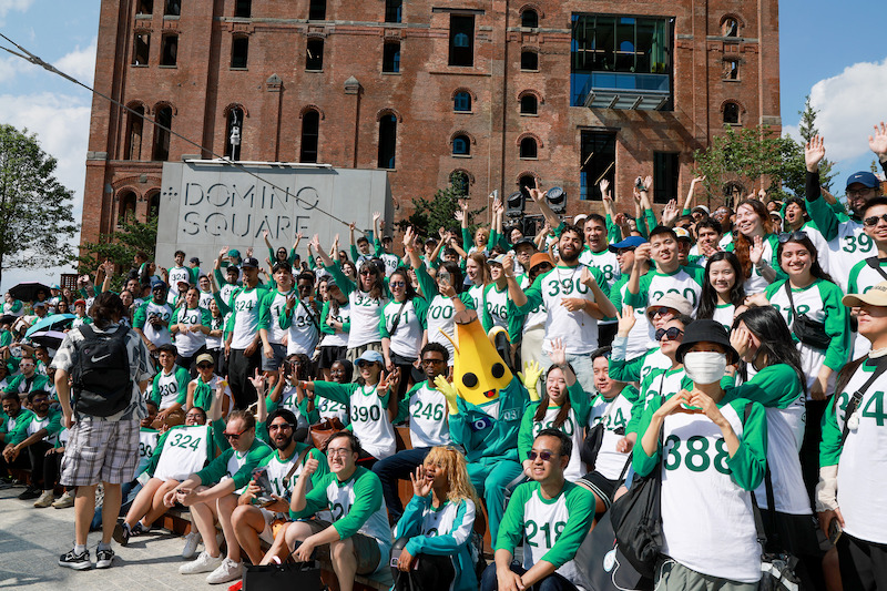 A crowd of fans at a 'Squid Game' Season 3 event at Domino Park in Brooklyn, New York.