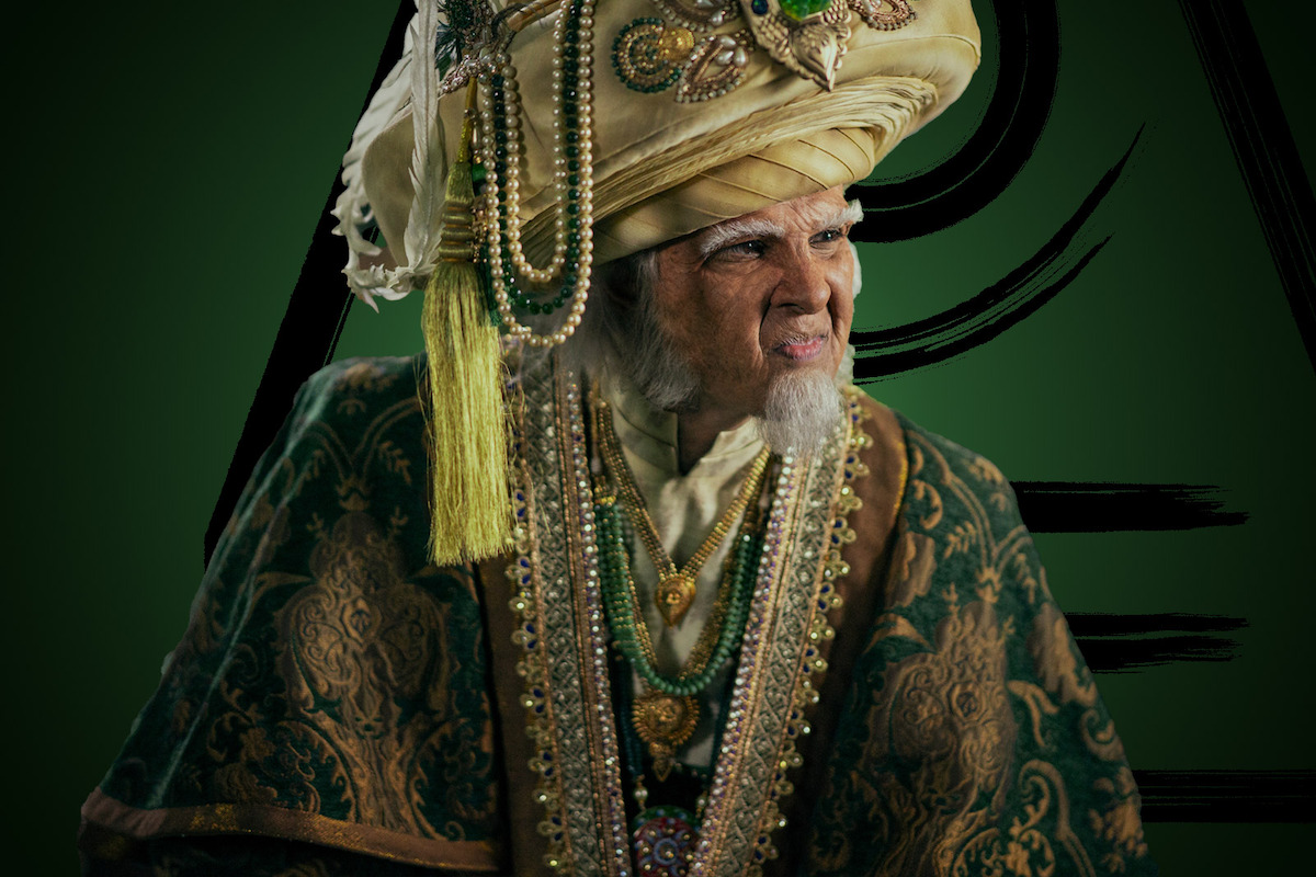 Utkarsh Ambudkar as King Bumi wears ornate green robes in season 1 of ‘Avatar: The Last Airbender'