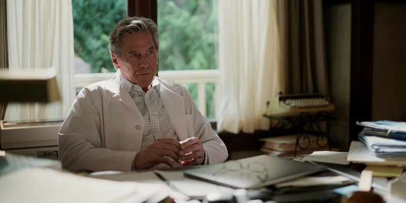 Tim Matheson as Doc Mullins sits on his desk in Season 5 of ‘Virgin River.’