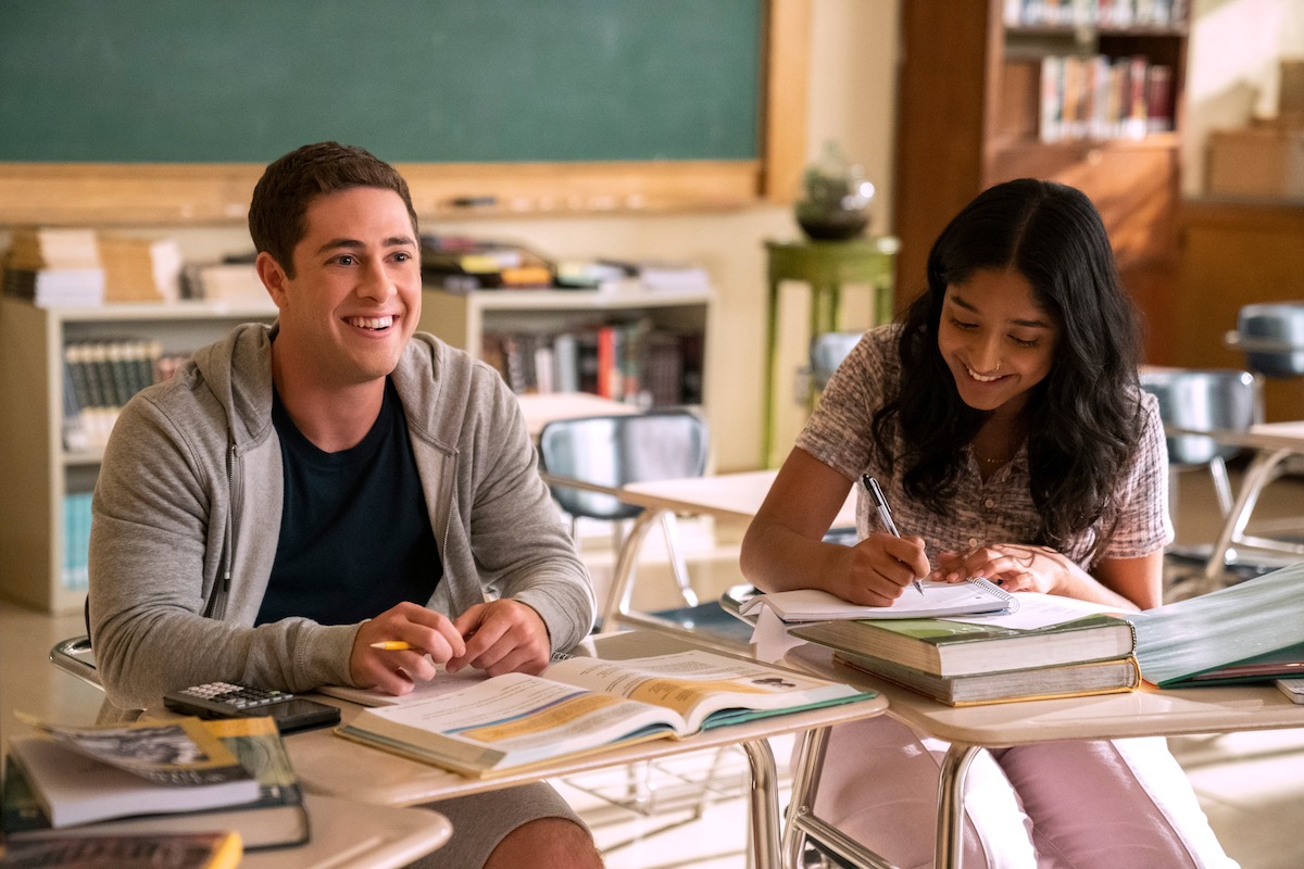 Jaren Lewison as Ben Gross and Maitreyi Ramakrishnan as Devi sitting in a classroom in ‘Never Have I Ever’ Season 4. 