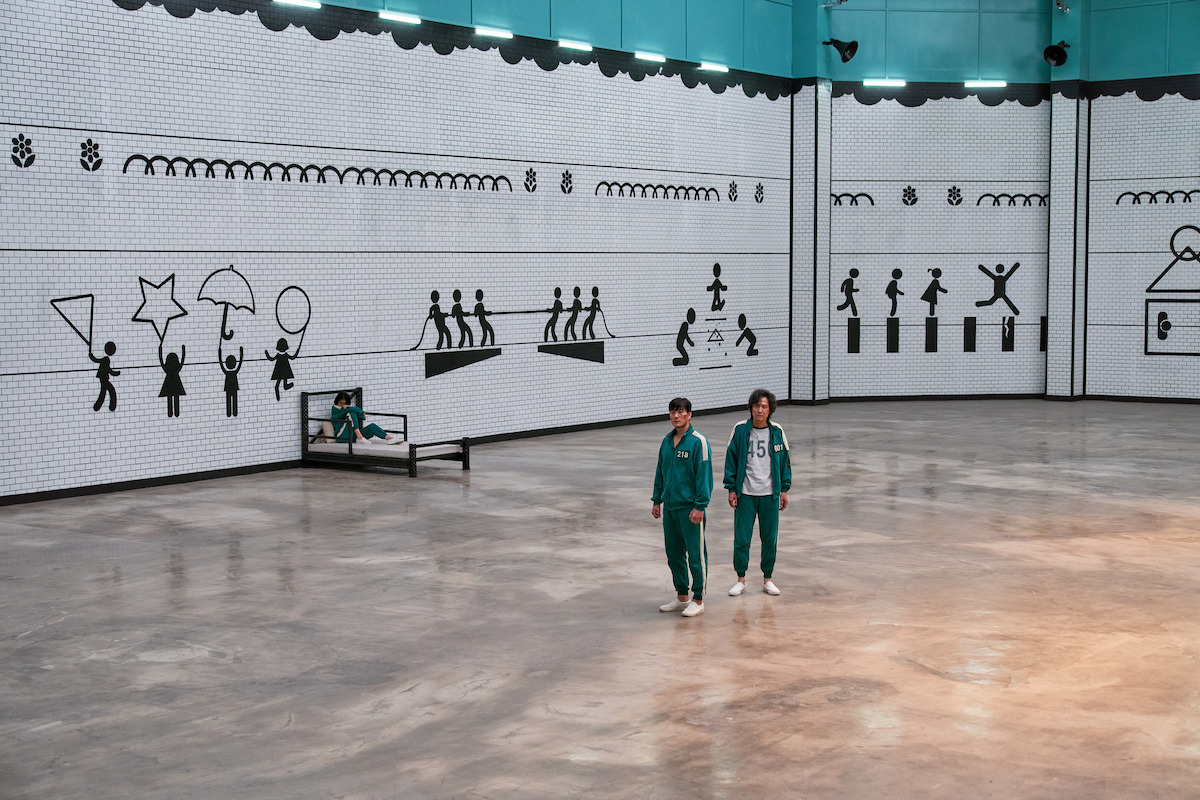 Squid Game S1 (L to R) Park Hae-soo as Cho Sang-woo, Lee Jung-jae as Seong Gi-hun in Squid Game S1 Cr. No Ju-han/Netflix © 2021