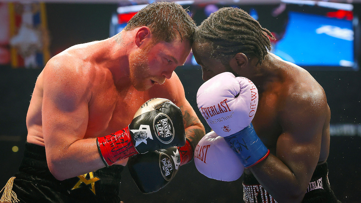 Canelo Alvarez exchanges punches with Terence Crawford.