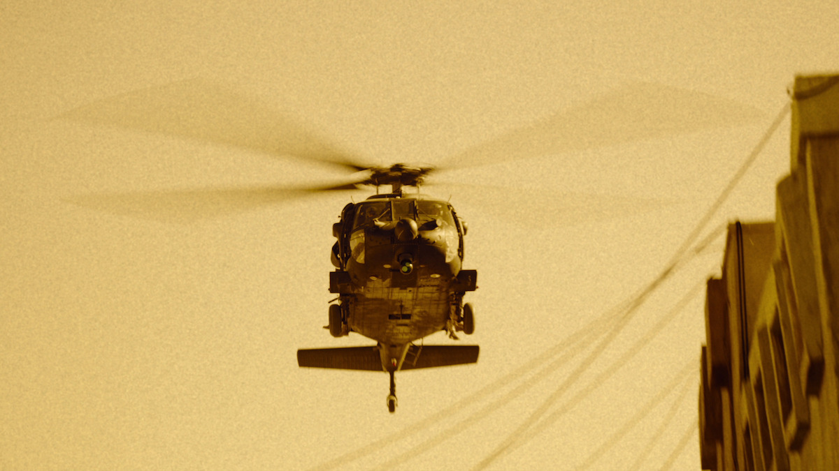 A Black Hawk flies over the city