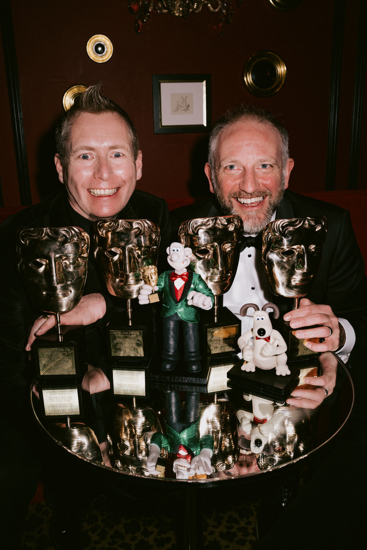 Merlin Crossingham and Richard Beek with their Wallace and Gromit puppets and their BAFTA awards