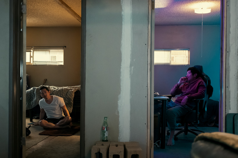 two men in bedrooms next to each other