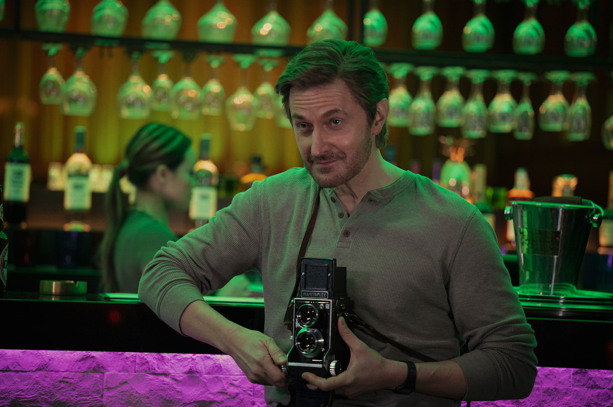 Man holds camera in bar in ‘Stay Close’