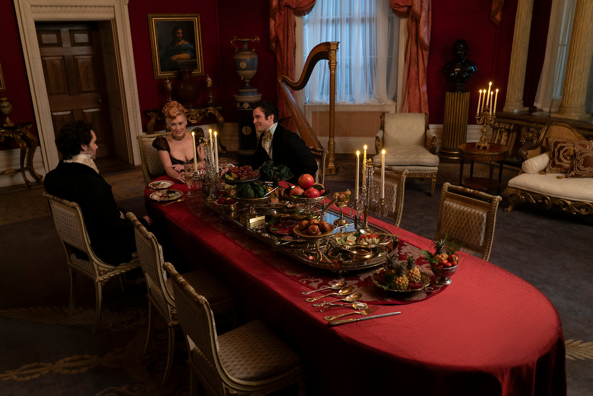 Lucas Aurelio as Paul Suarez, Hannah New as Lady Tilley Arnold, and Luke Thompson as Benedict Bridgerton dine together in Season 3 of ‘Bridgerton.’