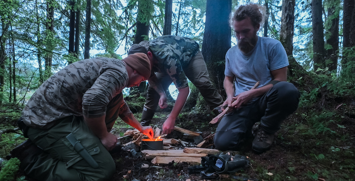 Drew Haas, Drake Vliem and Sammy Norris making a fire in ‘Outlast’ Season 2.