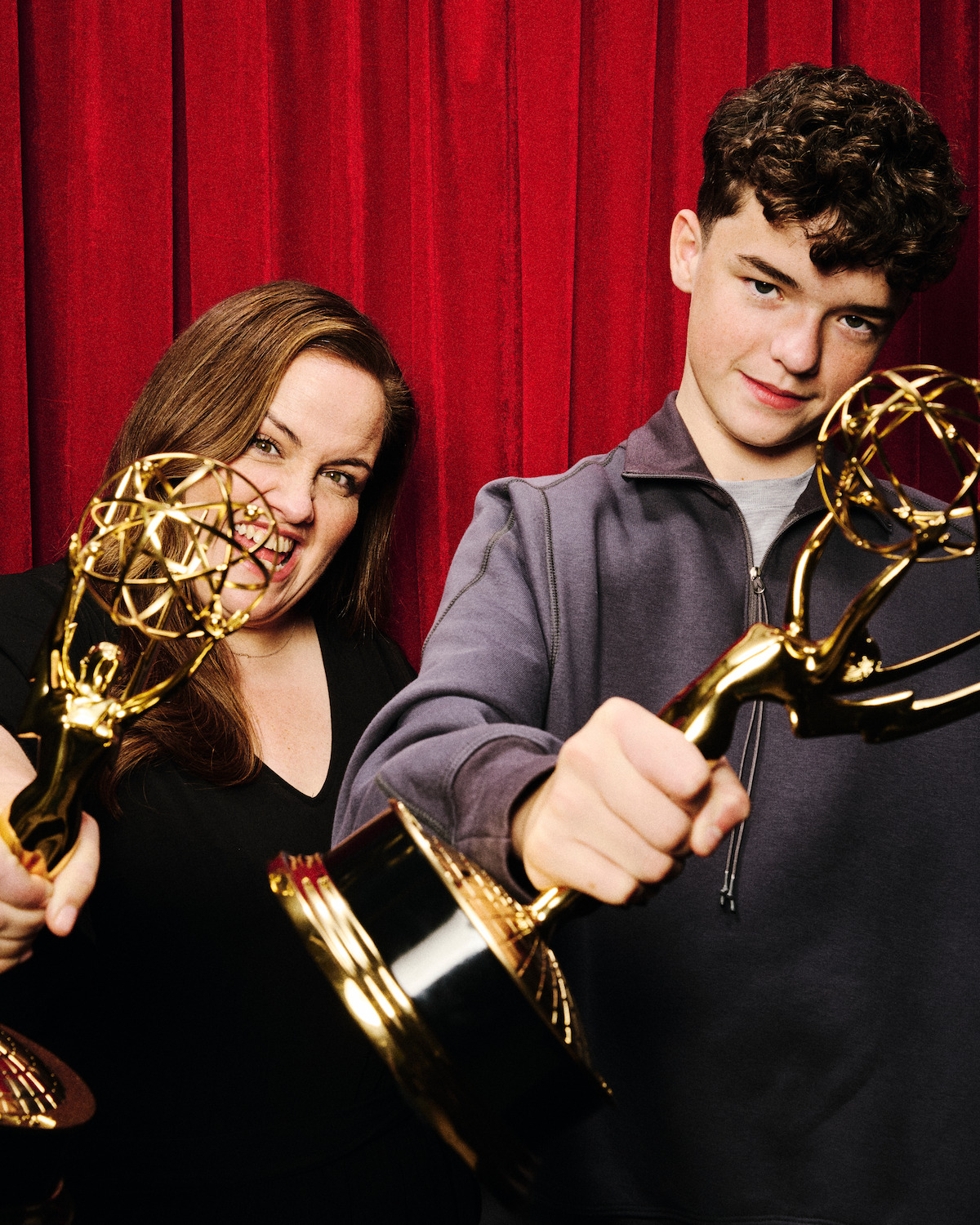 Jessica Gunning & Owen Cooper in a photobooth holding their Emmys