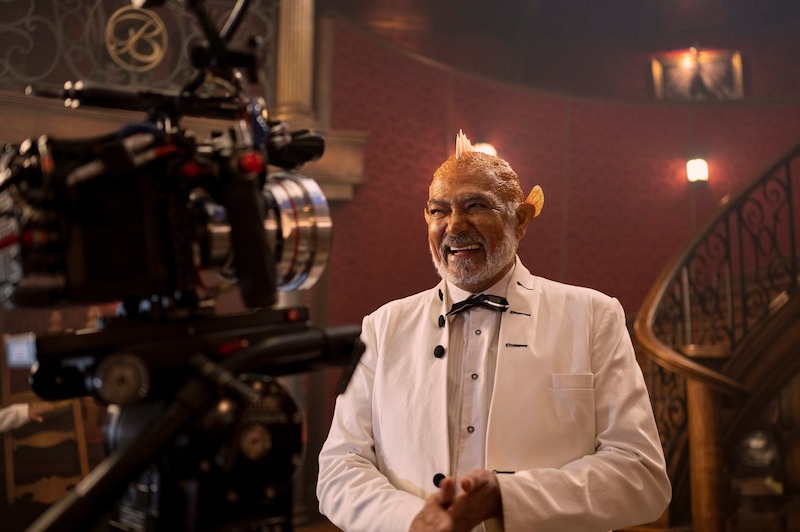 Royston Stoffels as Baratie Maître d’ smiles at the camera on the set of Season 1 of 'One Piece.' 