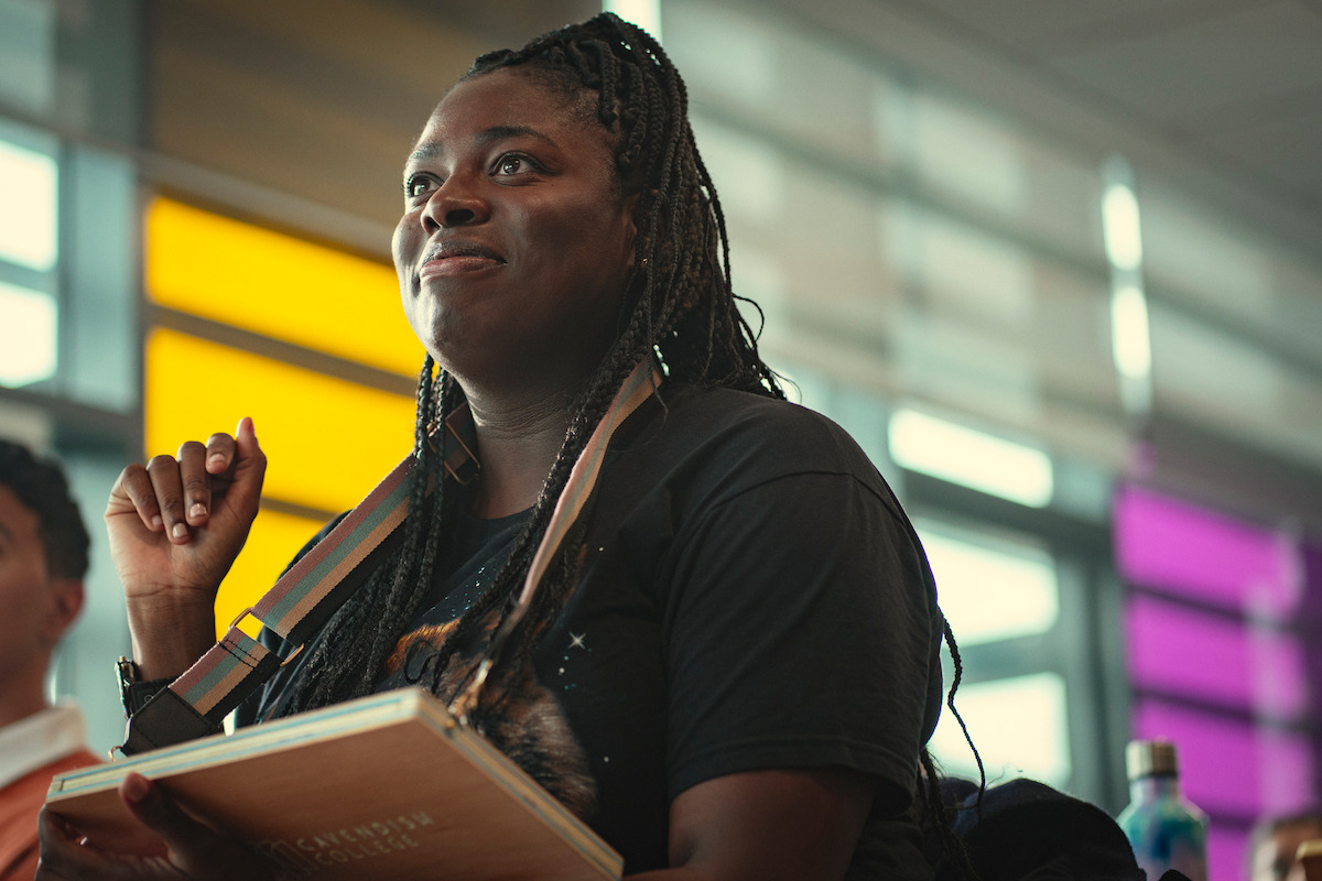 Chinenye Ezeudu as Viv sits at school holding a tablet in Season 4 of ‘Sex Education.’