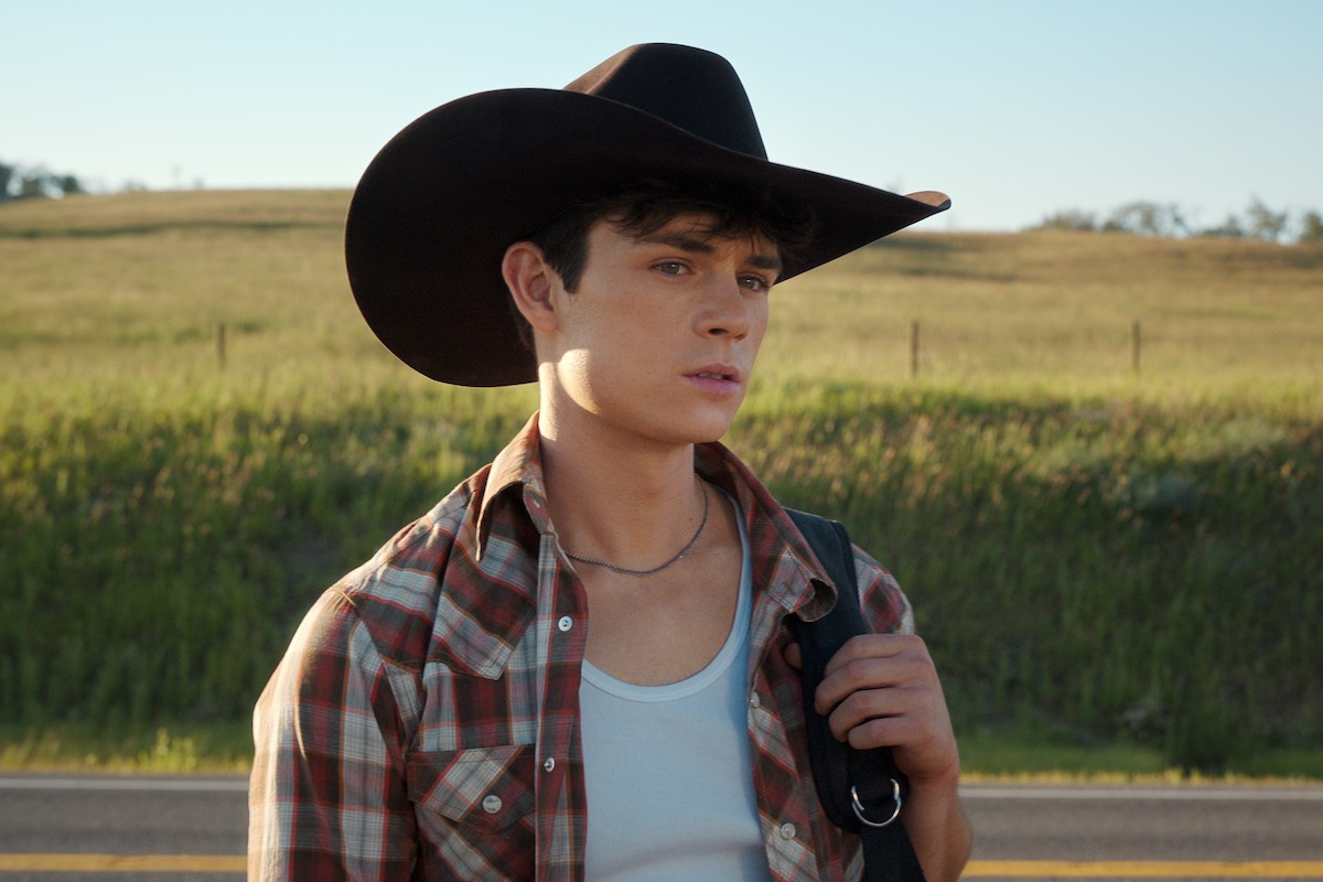 Ashby Gentry as Alex wearing a cowboy hat and flannel shirt in ‘My Life with the Walter Boys’ Season 2.