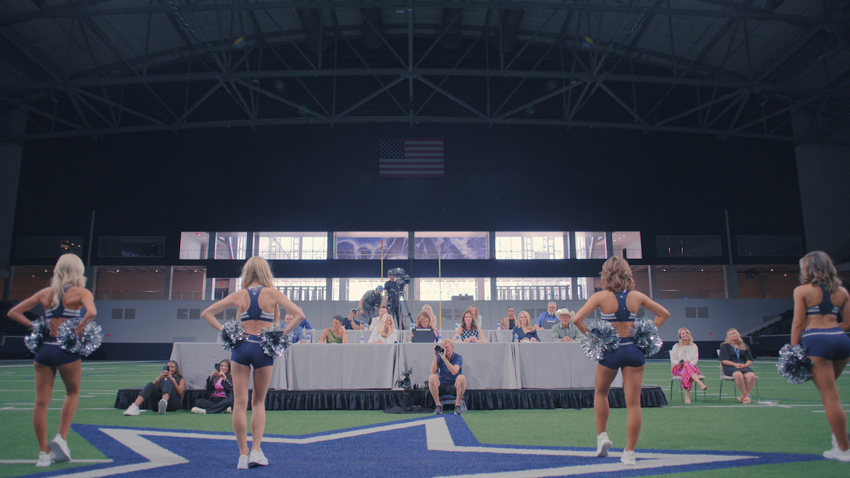 Cheerleaders train in front of Kelli Finglass and Judy Trammell.