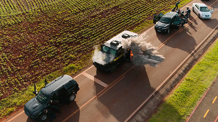 Trailer still for Season 1 of 'Criminal Code' showing an explosion in a truck on a rural highway