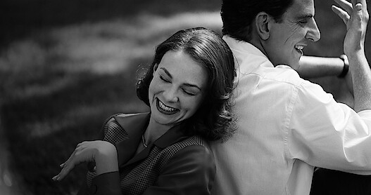 Bradley Cooper and sitting in a meadow