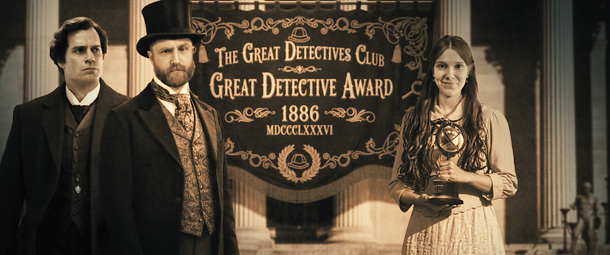 Three people in Victorian-era attire stand before a banner reading "The Great Detectives Club Great Detective Award 1886"; one woman holds a trophy, the scene set within grand architectural columns, evoking a formal ceremony.