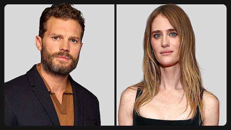 A man with short curly hair and a beard wearing a dark jacket and brown shirt, and a woman with long blonde hair in a black top, both posing against a plain light grey background divided by a black border.