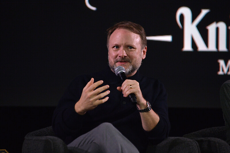 Rian Johnson sits on stage during the panel from The Lineup