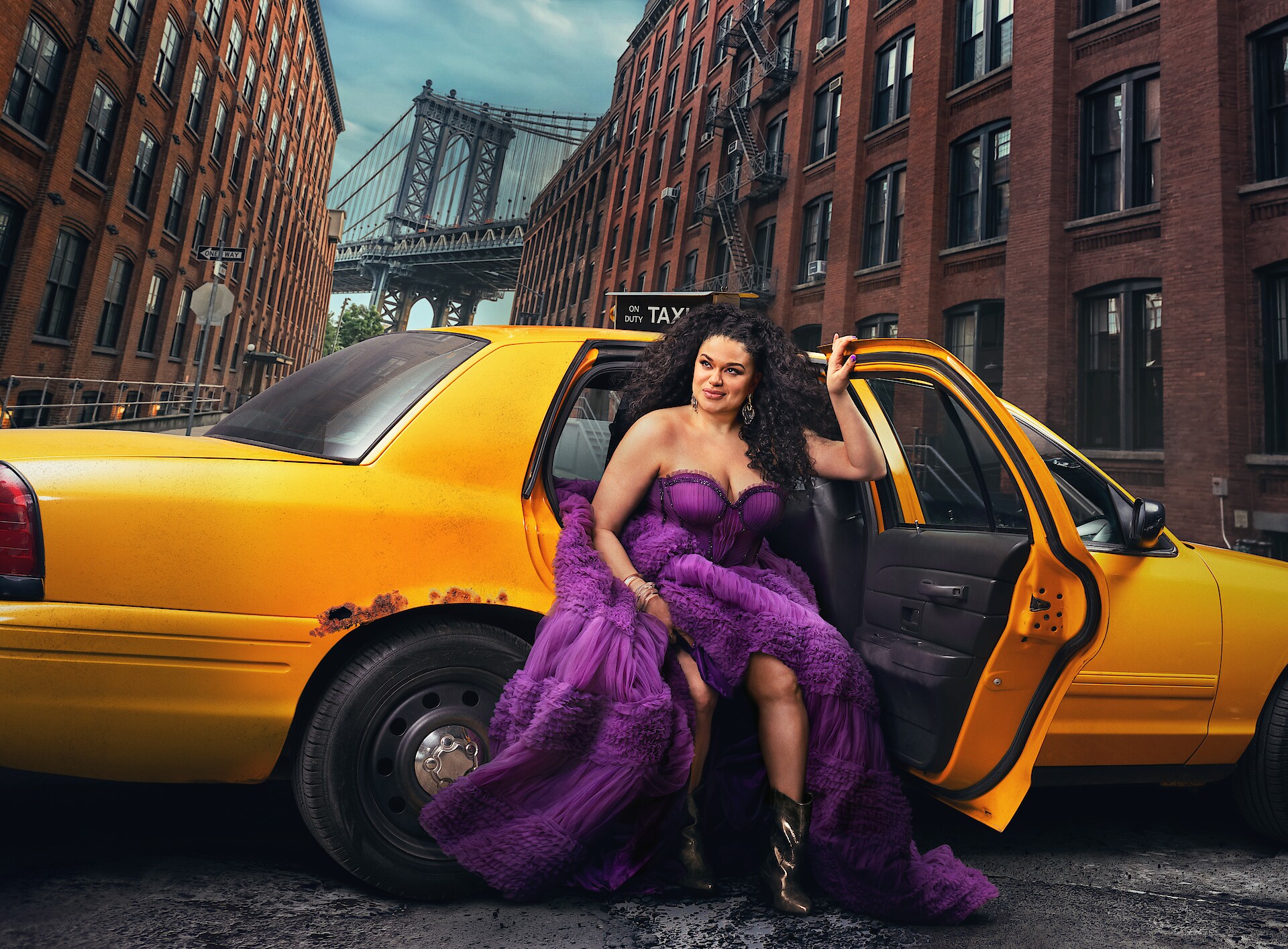 Survival of the Thickest key art - Michelle Buteau in a flowing purple dress stepping out of a taxi in NYC. 