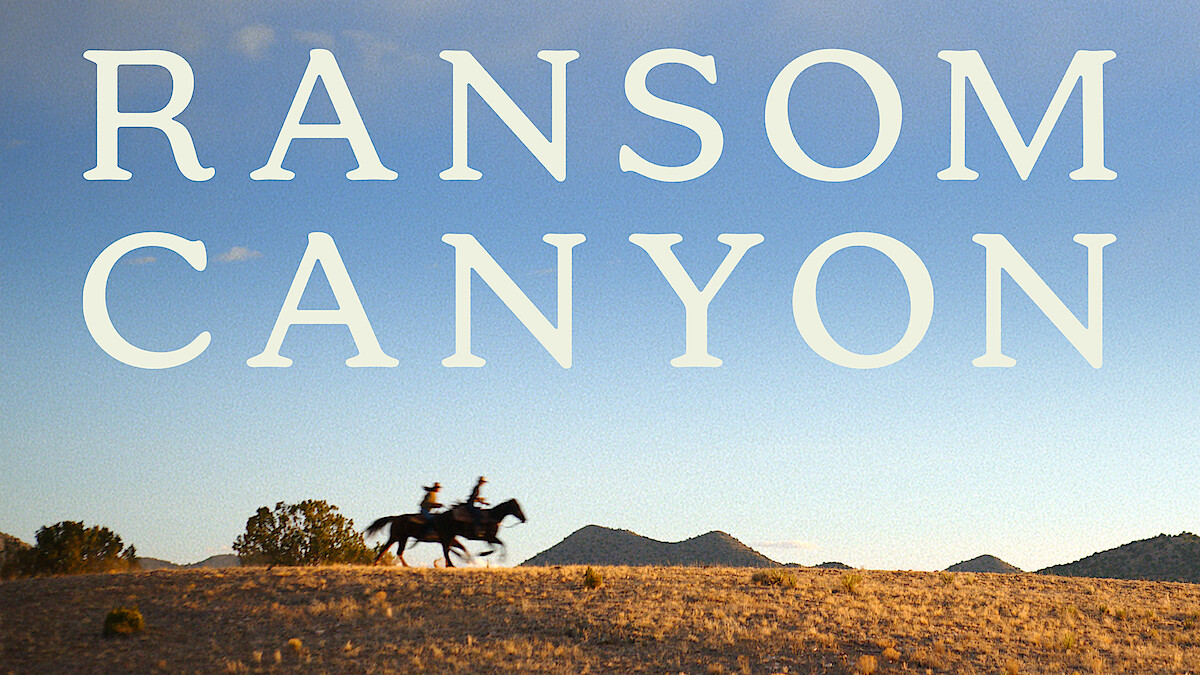 Two drivers on horseback cross a grassy hill under a clear blue sky. The words 'ransom canyon' are prominently displayed in large, fat letters on the top of the picture.