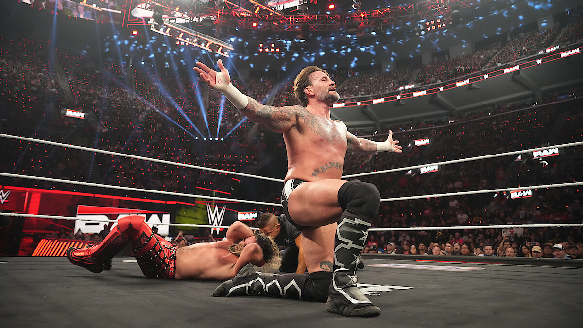 Seth Rollins and CM Punk in the ring.