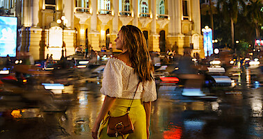 Rachael Leigh Cook crosses a street in a still from A Tourist's Guide to Love.