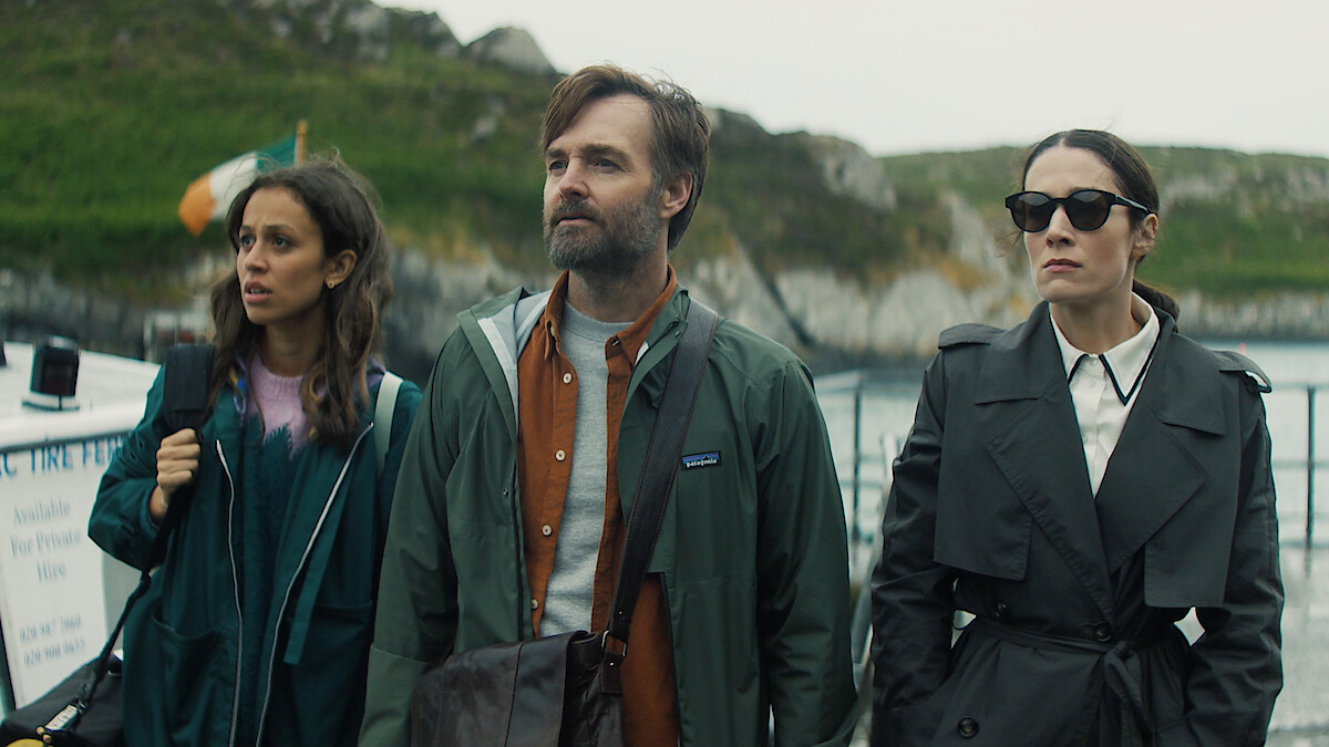 Will Forte as Gilbert Power, Robyn Cara as Emmy Sizergh and  Siobhán Cullen as Dove stand together with mountains and water in the background in 'Bodkin'