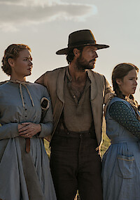 A family looks off into the distance together.