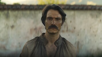 Claudio Cataño as Colonel Aureliano Buendía stands with an intense introspective expression in 'One Hundred Years of Solitude'