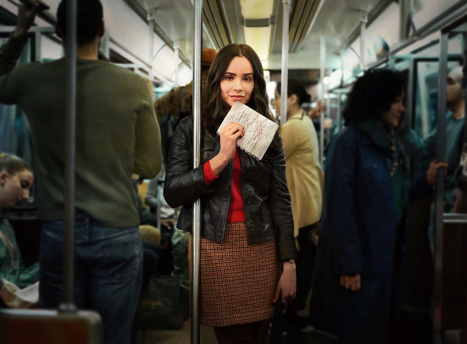 The Life List key art - Sofia Carson on a subway train holds a list up in her hand. 