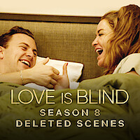 Daniel and Taylor are laughing and engaging in a playful thumb wrestling match while relaxing in bed together.