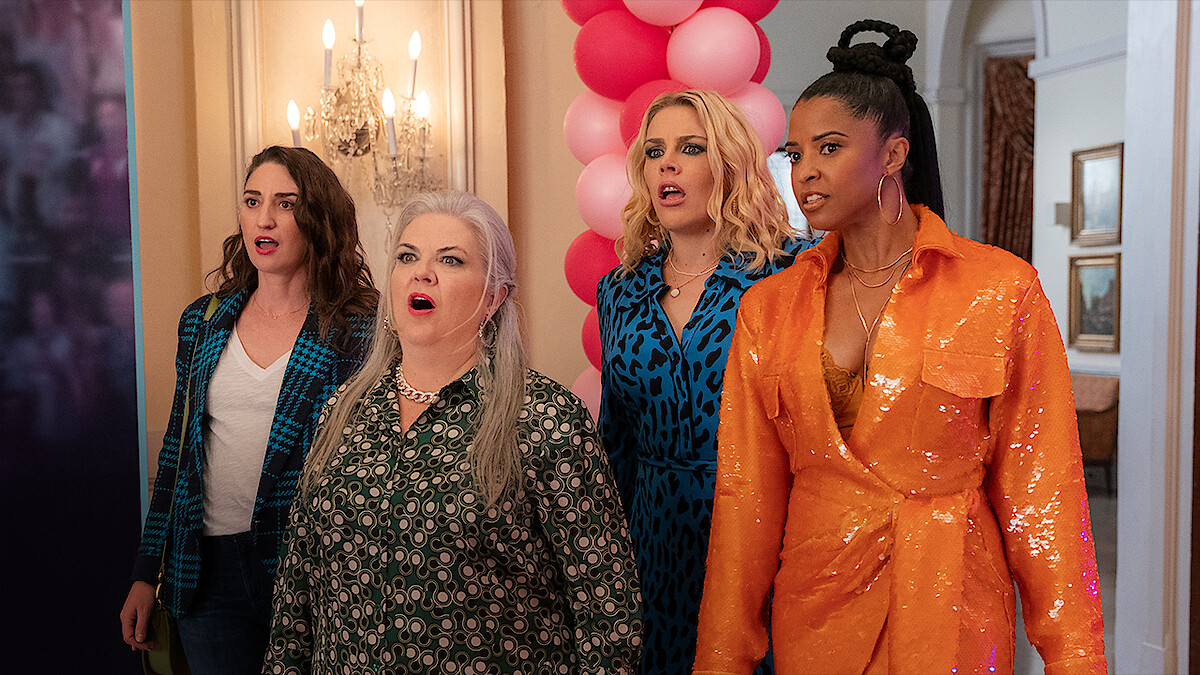 Busy Philipps as Summer, Paula Pell as Gloria, Renee Elise Goldsberry as Wickie, and Sara Bareilles as Dawn enter a room with their mouths open in shock in Season 3 of 'Girls5eva'