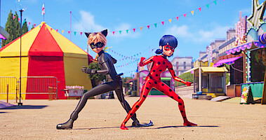 Two illustrated figures standing at the entrance of a fair. One is dressed like a cat, the other as a ladybug.