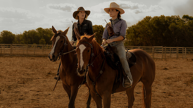 Anna Torv as Emily Lawson and Philippa Northeast as Susie Lawson ride horses on a ranch in Season 1 of 'Territory'