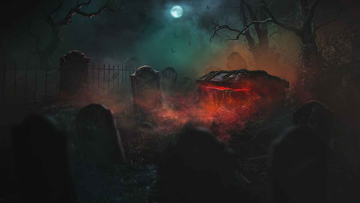 Spooky graveyard at night under a full moon, with mist and bats in the sky, dead trees, old tombstones, and a glowing red light emanating from an ominous crypt or grave.