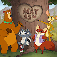 Four animated woodland animals stand in front of a large tree with "May 22nd" carved in a heart on the trunk, set in a forest with mountains in the background. The animals look cheerful and are holding wooden mallets.