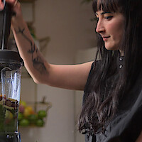 Maya Okada Erickson using a blender in ‘Hack Your Health: The Secrets of Your Gut’