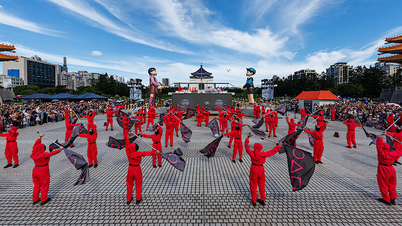Pink Guards wave flags at a 'Squid Game' Season 3 fan event in Taipei, Taiwan.