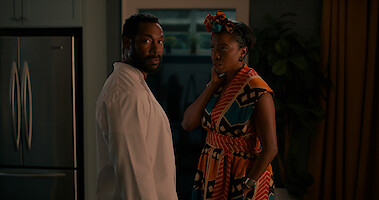 Two people standing in front of a doorway