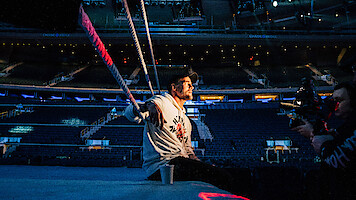CM Punk sits on the side of the ring.