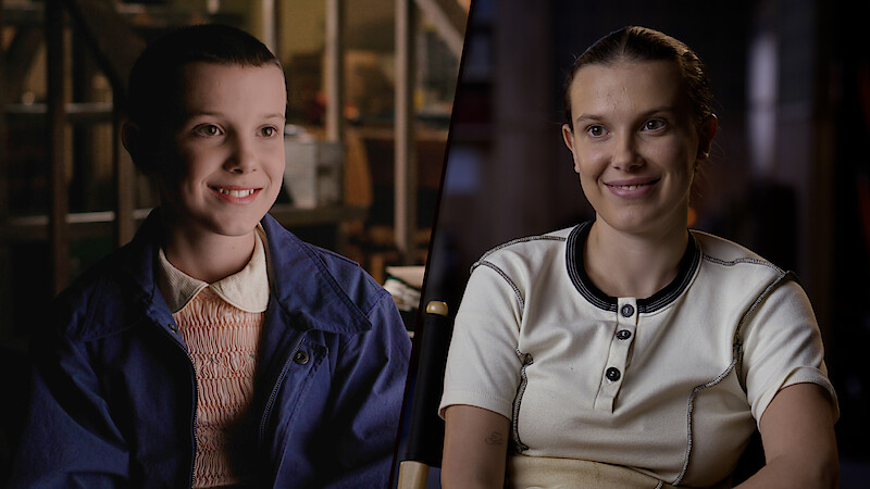 A split-screen contrasts Millie Bobby Brown in Season 1, with short hair and a blue jacket, smiling in a brightly lit room, and her Season 5 look, wearing a white shirt and smiling softly in a dimly lit indoor setting.
