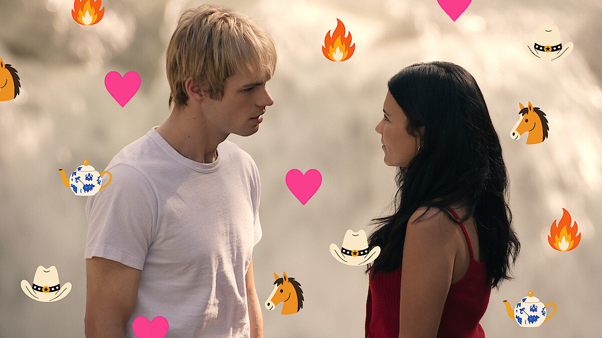 A young man and woman stand facing each other outdoors, possibly near a waterfall. Colorful icons of hearts, flames, horses, cowboy hats, and teapots are overlaid on the image, adding a playful, romantic tone.